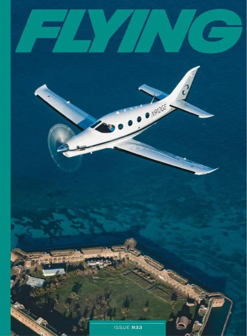 Magazine cover with an airplane flying over a coastal area, featuring the word 'FLYING'.
