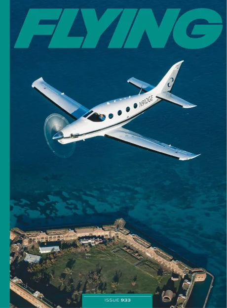 Magazine cover with an airplane flying over a coastal area, featuring the word 'FLYING'.